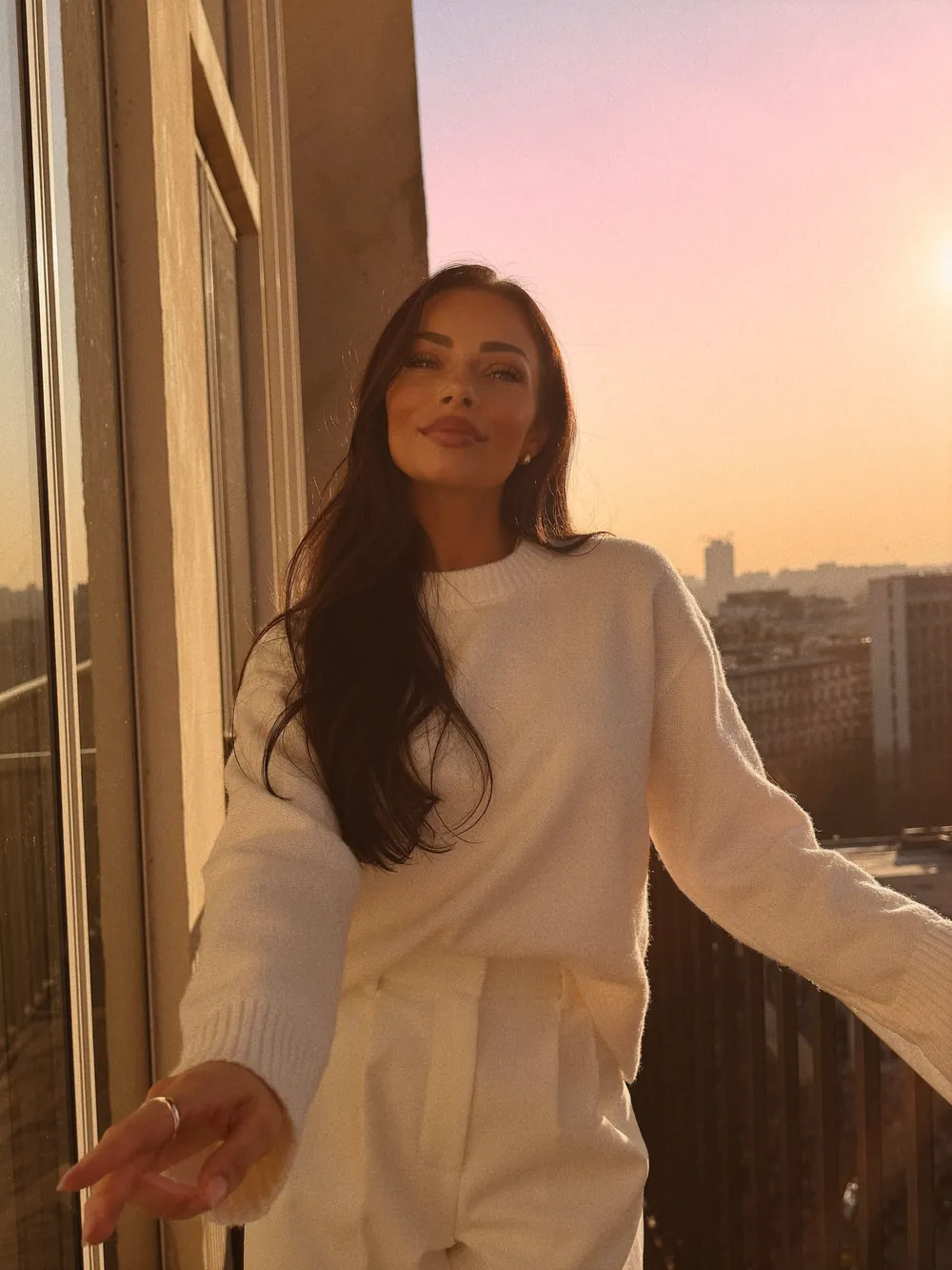 Ani Shanti on a balcony at sunset
